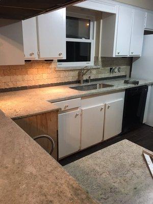 New floors, counters, and backsplash