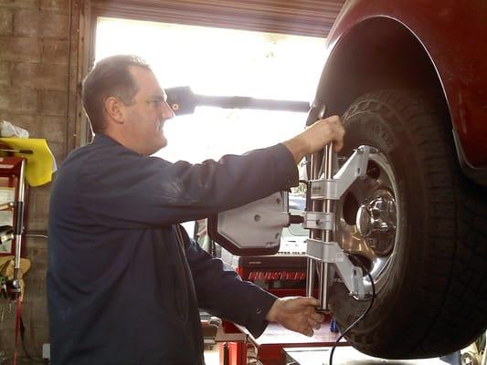 This hard worker is using the state of the art wheel alignment machine.