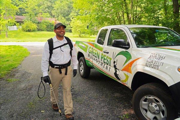 Green Pest Management pest technician and service truck.