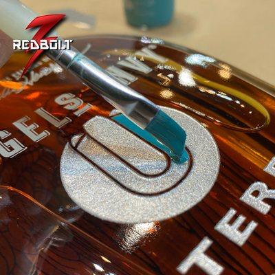 Customer appreciation glass carved/etched and paint-filled whiskey bottles with company logo for the 2022 Holiday Season.