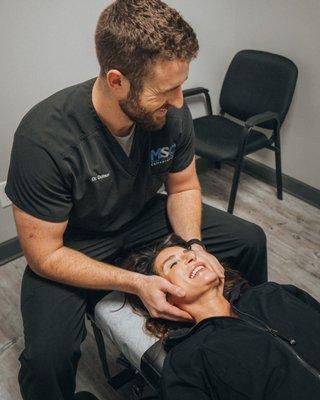 Performing a cervical motion assessment.