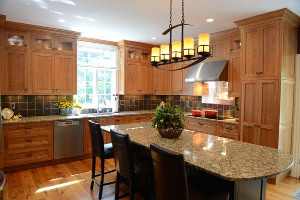 Flush inset stained cherry cabinetry with Italian granite counter tops