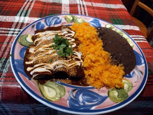 Enchiladas de Pollo con Mole, served with rice and beans