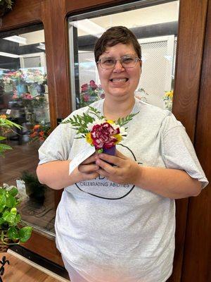 Me holding a flower that I made