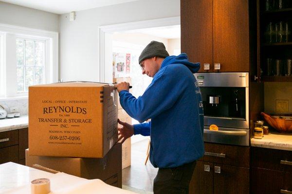 Crew member packing for a residential move.