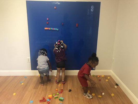 Here's a photo of children utilizing our lego wall!