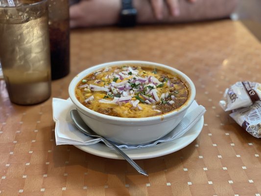 Chili with topped with onions and cheese