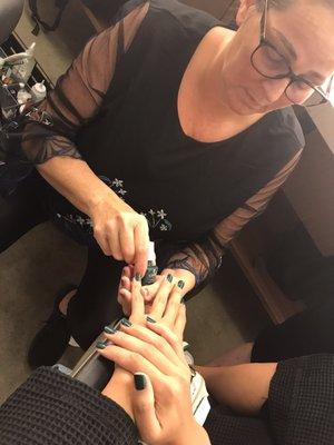 Barbara polishing nails to perfection