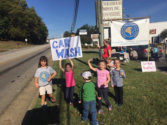 The children help with the car wash