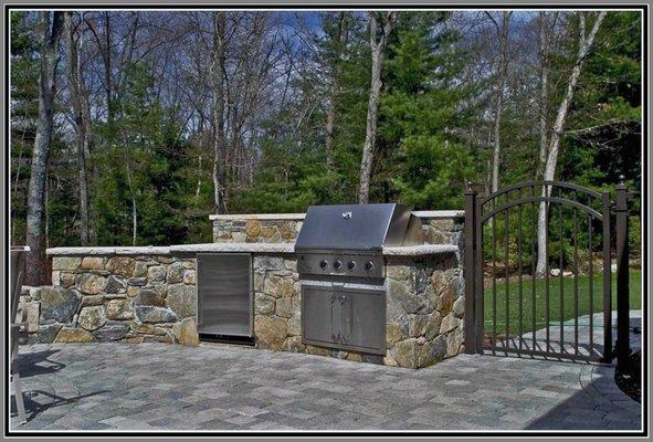 Outdoor kitchen- built-in grill and granite countertop.