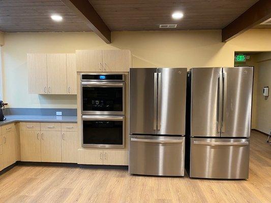 Kitchen as 2 refrigerators and 2 ovens on this wall