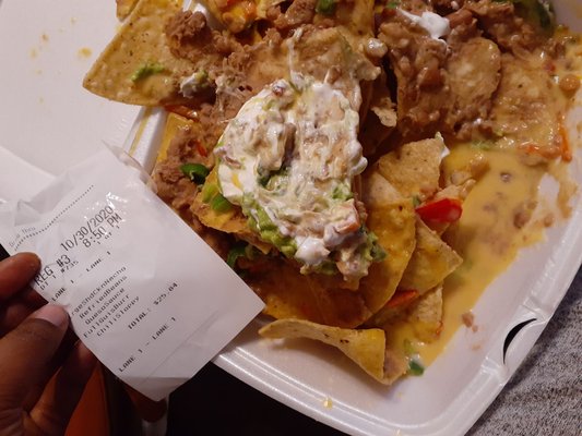 My "shredded chicken" nachos with queso sauce (no shredded chicken found).