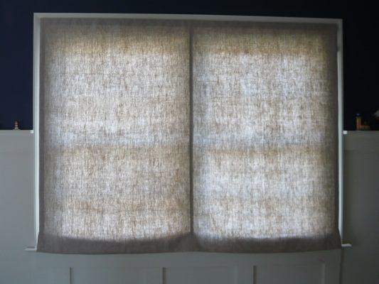 Sheer soft roman shade on a double window