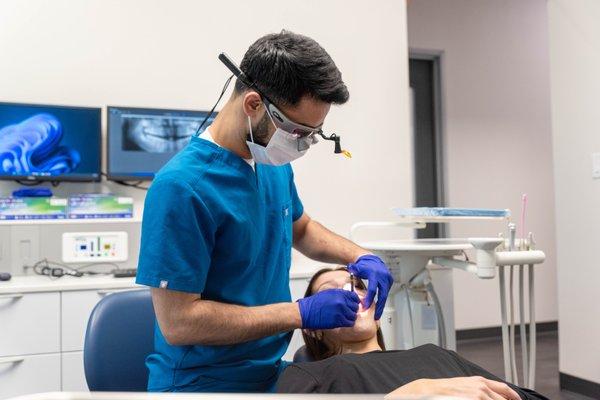 Dr. Siddiqui treating a patient during their visit at Advanced Family Dental of Midlothian