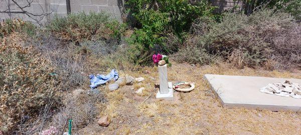 Many grave sites are covered in dirt, stones, tumble weeds