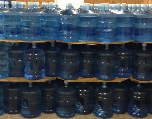 These five gallon bottles are ready to go in Bloome Water's warehouse.