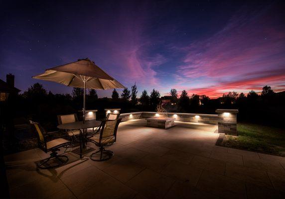 Paver patio, seat wall, fire pit, wall lighting, outdoor dining.