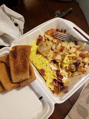 Pastrami omelet with Swiss cheese and hash Browns and wheat toast.