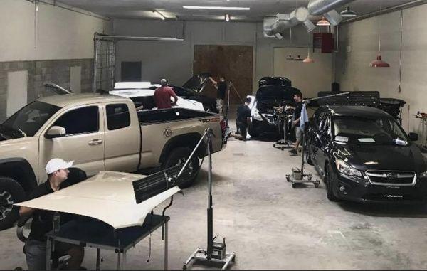 Our paintless dent repair (PDR) team repairing cars that have damage from hail storm.