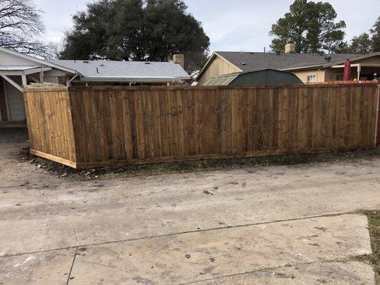 Pressure Treated 6ft privacy fence with 1x4 top trim, Walnut Stain. Completed 1/29/2021