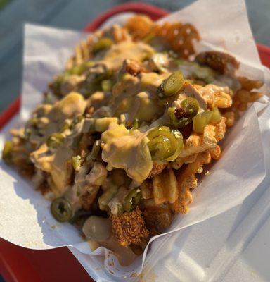 Chipotle Fry Basket, Loaded with nacho cheese, jalapeños, pickles, and our house Chipotle lime sauce. Fan Favorite