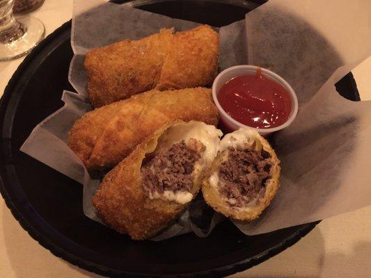 Cheesesteak egg rolls (one broken in half)