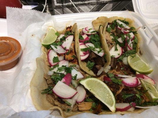 Variety of tacos, including carnitas, al pastor, barbacoa, carne asada, and lengua.