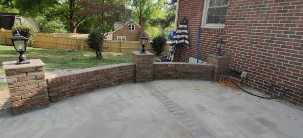 Stone wall with concrete patio