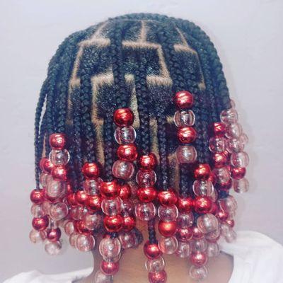 Kid's braids with beads. Singles in the back cornrows on the top.