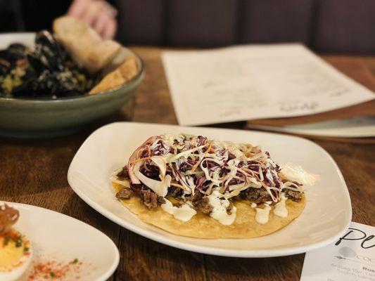 Brisket Taco with Serrano crema and white cheddar.