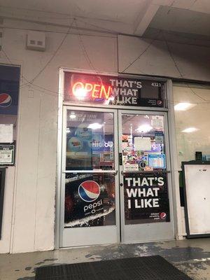 Front door with the open sign lit up.