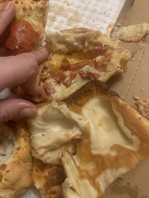 Under cooked calzone part of the Batman pizza and deep dish