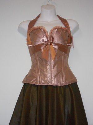 copper color satin corset, with a wet look brown skirt.