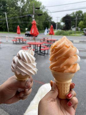 A vanilla and chocolate swirl soft serve, and a vanilla and orange swirl cone.