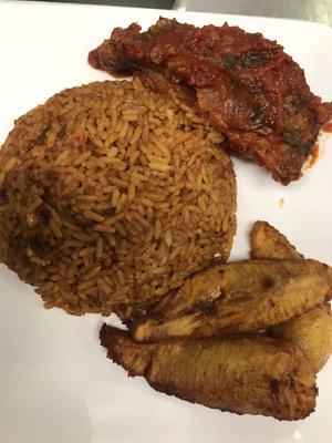 Jollof rice with stewed fish and plantains.