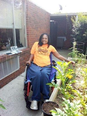 Kristen Brown in our vegetable garden outside in the courtyard.