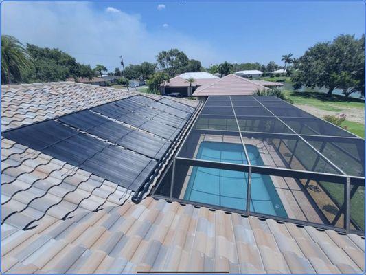 Aquatherm solar pool heating system on a tile roof.