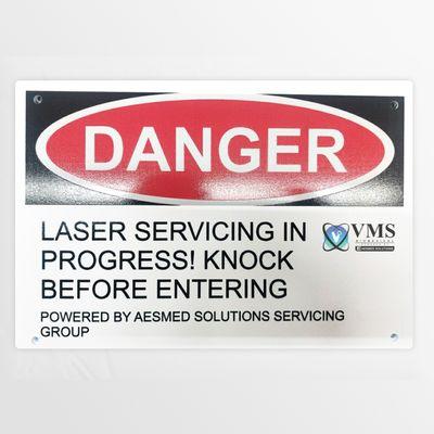 Signage we use when doing service to warn people that we are working on their lasers.