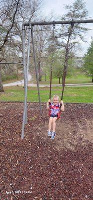 My granddaughter swinging.