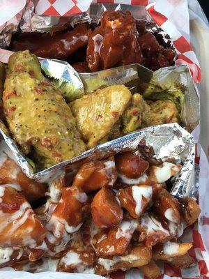 Dom sauce wings at the far end, lemon pepper in the middle and loaded fries near