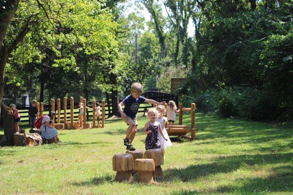 A natural playground with creek access allows for creative outdoor play.