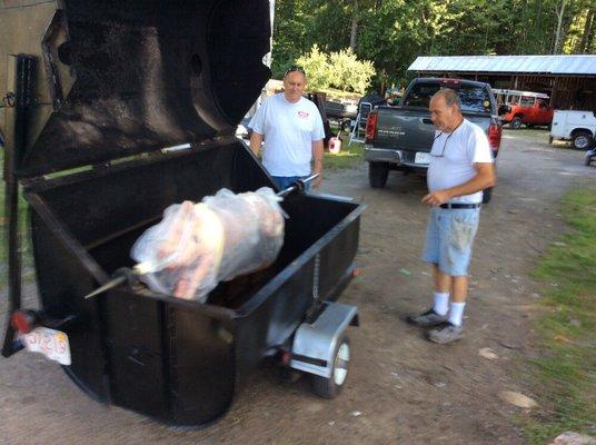 Pig roast - picking up the pig