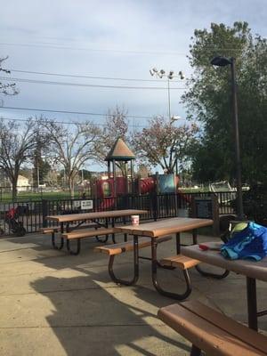 Little kids play area, slide, jungle gym. Picnic tables too