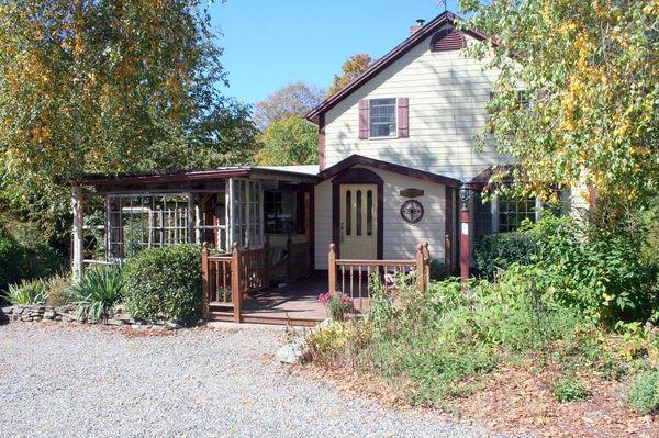 Quintessential Turn of the Century Enchanted Property! Step Back in Time in this Captivating Cream Colored Colonial with Cran...