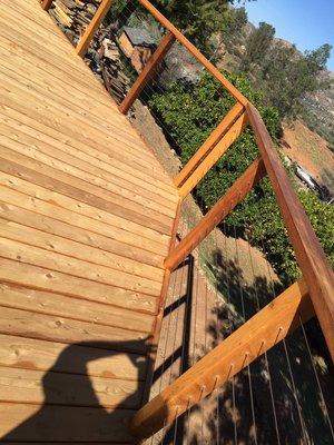 Cable railing for a wooden deck.