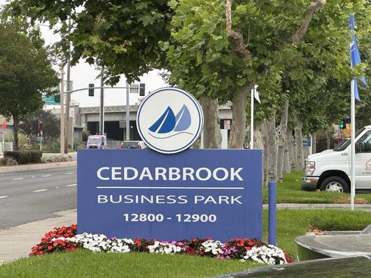 Turn into driveway with Cedarbrook sign. After in lot, turn right to face school.