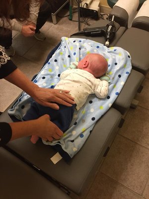 Dr. Beth gently checks and adjusts babies!