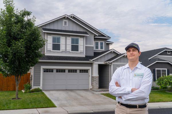 Green Pest Management pest technician standing in front of a residence.