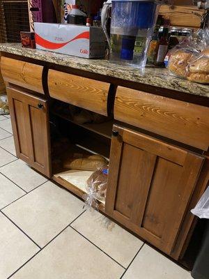 Legacy Mansion luxury kitchen with missing door and partial cabinet