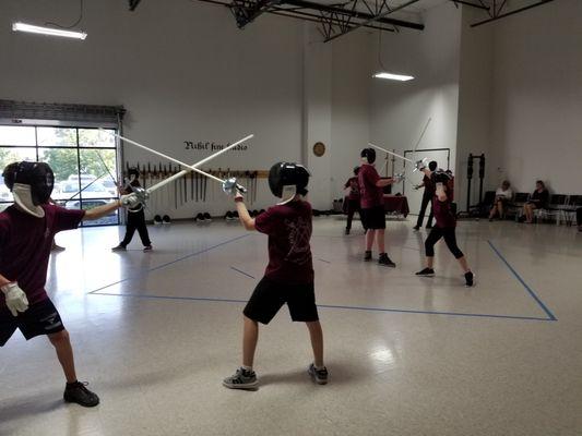 Teenagers fencing at the Noble Science Academy